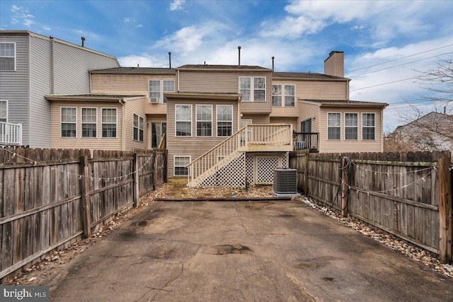 back of property featuring central AC unit and a patio