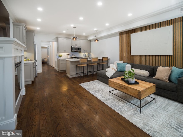 living room with ornamental molding and dark hardwood / wood-style flooring