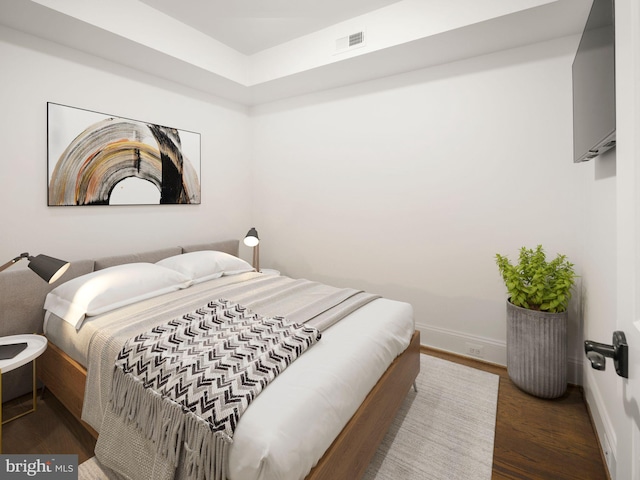 bedroom featuring dark hardwood / wood-style flooring