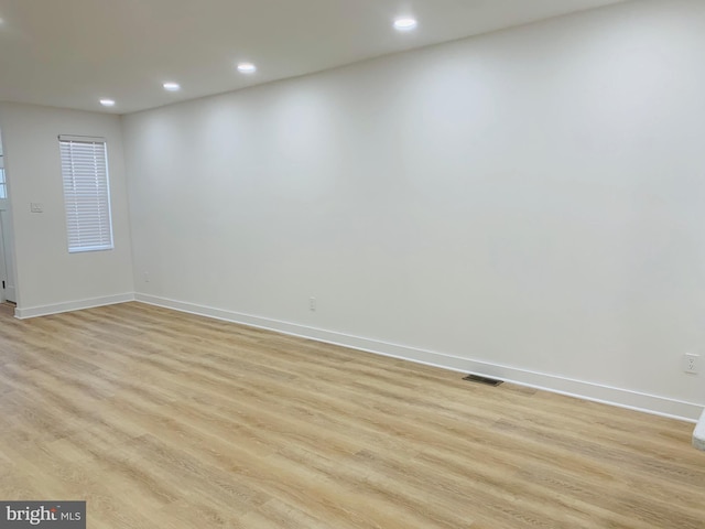 unfurnished room with light hardwood / wood-style floors