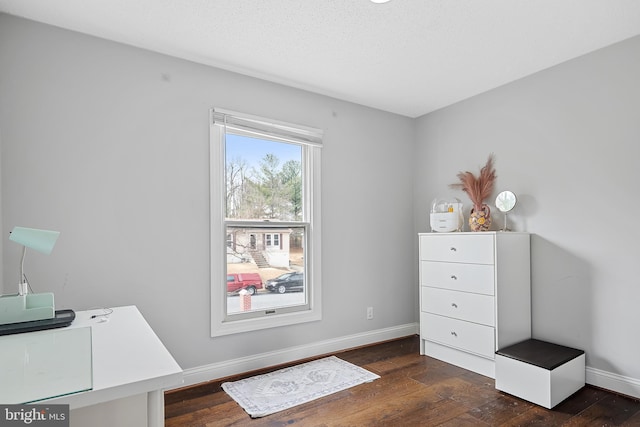 unfurnished office with dark hardwood / wood-style flooring and a textured ceiling