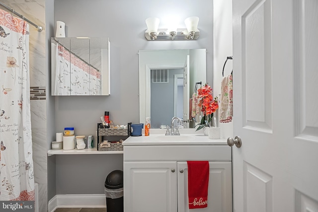 bathroom with vanity and curtained shower