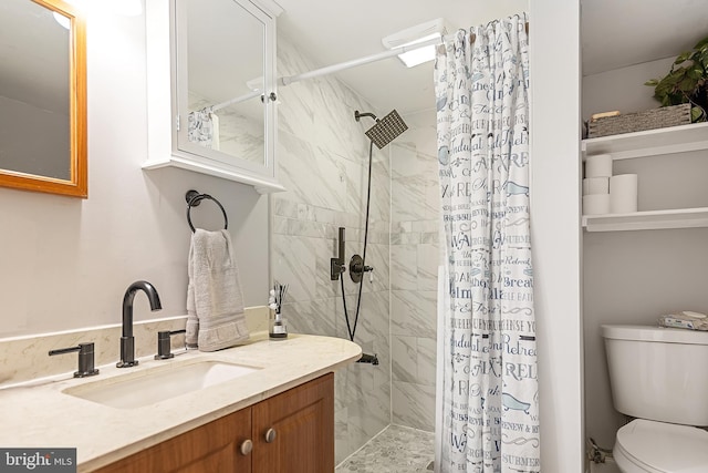 bathroom featuring toilet, vanity, and walk in shower