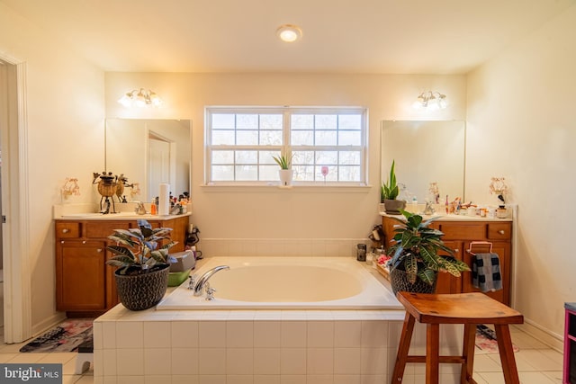 bathroom featuring vanity, tiled tub, and tile patterned flooring