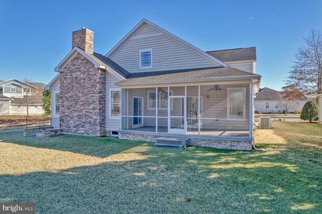 back of property featuring ceiling fan, a yard, a sunroom, and central air condition unit