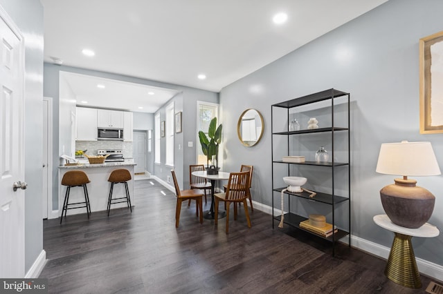 dining space featuring dark wood-type flooring