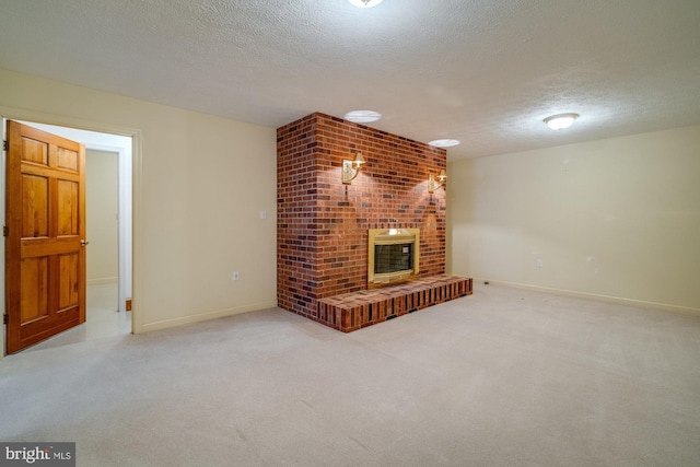 unfurnished living room featuring light colored carpet, a textured ceiling, and a fireplace