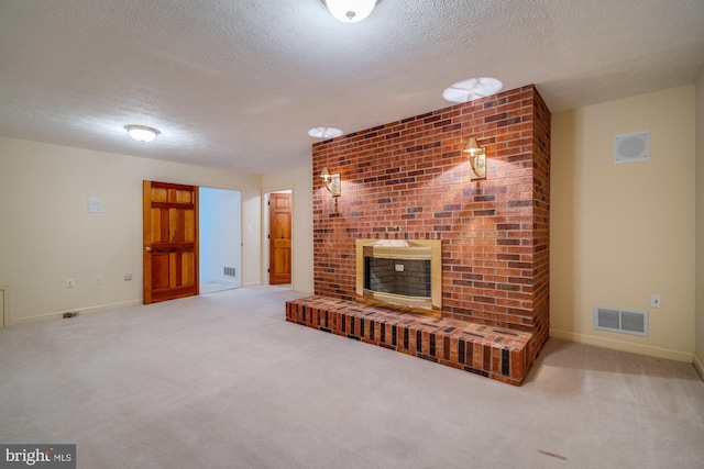 living room with carpet, a brick fireplace, and a textured ceiling