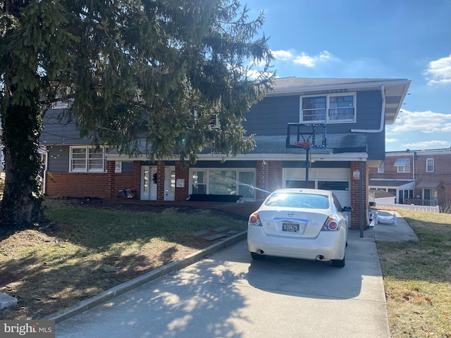 view of front of property featuring a garage and a front lawn