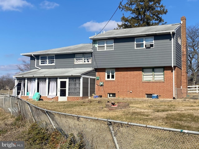 rear view of property with a lawn