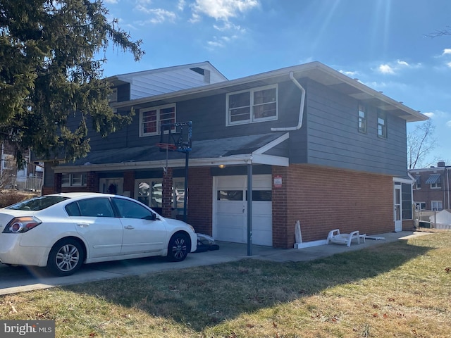 rear view of property with a garage and a lawn