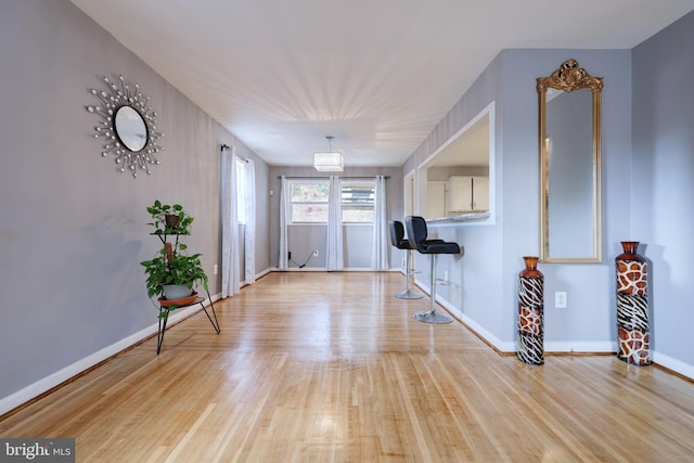 entryway featuring light hardwood / wood-style floors and a notable chandelier