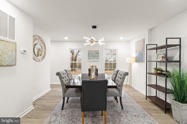 dining room featuring baseboards, recessed lighting, light wood-type flooring, and an inviting chandelier