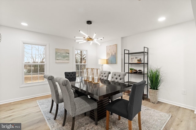 dining area with recessed lighting, light wood-style flooring, baseboards, and an inviting chandelier