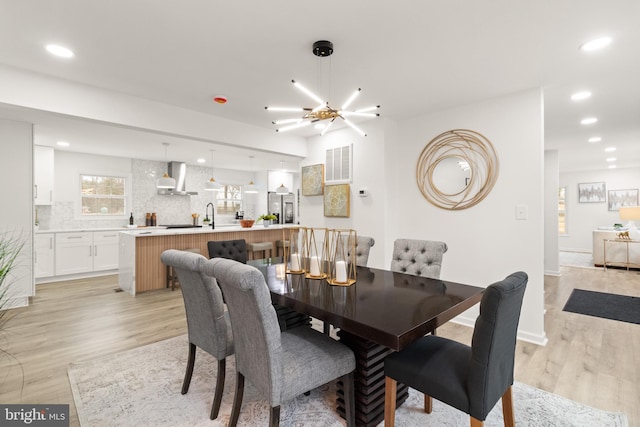 dining room featuring light wood-type flooring, baseboards, visible vents, and recessed lighting