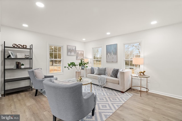 living area with recessed lighting, baseboards, and wood finished floors