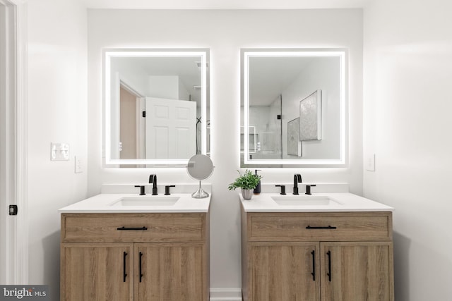 bathroom featuring two vanities and a sink