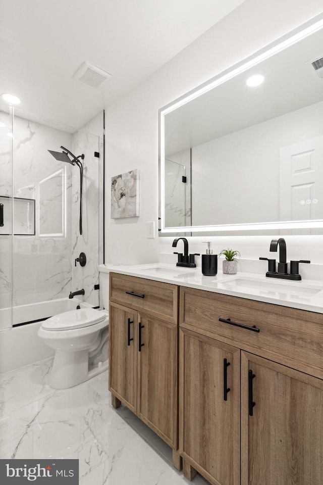 bathroom with toilet, a combined bath / shower with marble appearance, a sink, marble finish floor, and double vanity