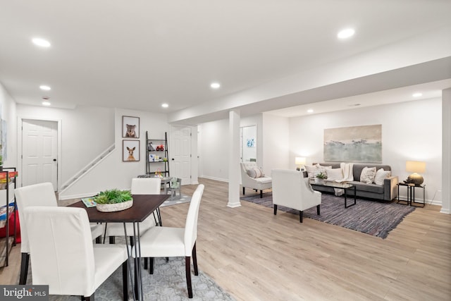 dining space with light wood-type flooring, baseboards, and recessed lighting