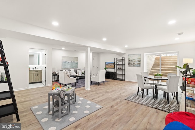 dining room with light wood-style floors and recessed lighting