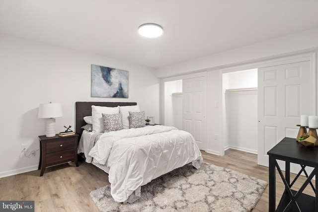 bedroom featuring light wood-style floors, a closet, and baseboards