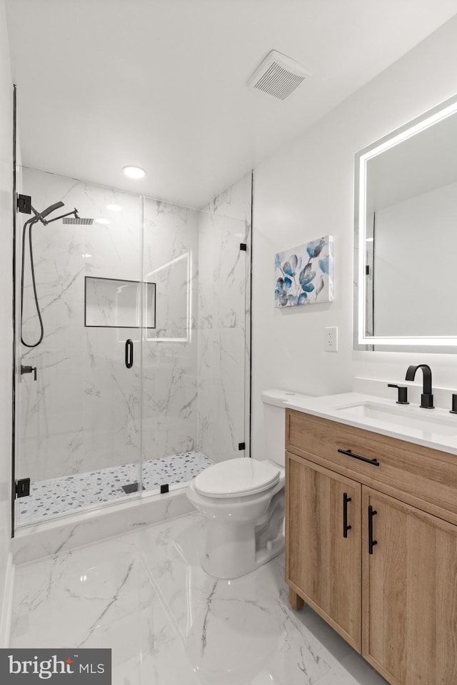 bathroom with marble finish floor, a marble finish shower, visible vents, toilet, and vanity