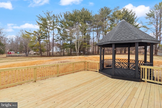 wooden deck featuring a gazebo and fence