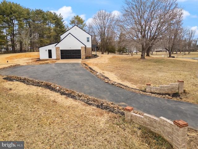 exterior space with a lawn and brick siding