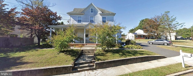 view of front of home featuring a front yard and a porch