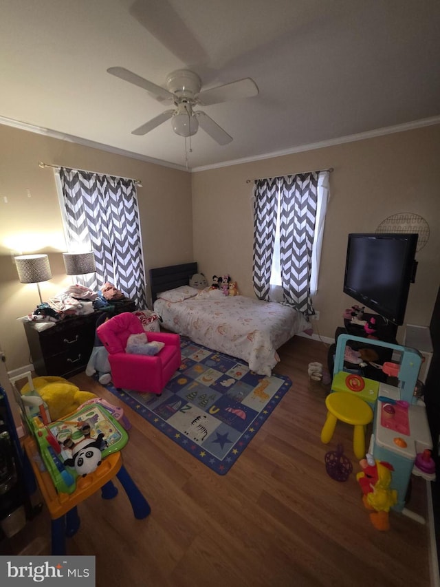 bedroom featuring hardwood / wood-style flooring, ornamental molding, and ceiling fan