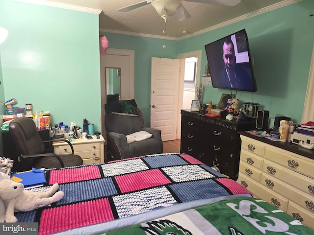 bedroom with crown molding, ceiling fan, a textured ceiling, and hardwood / wood-style flooring