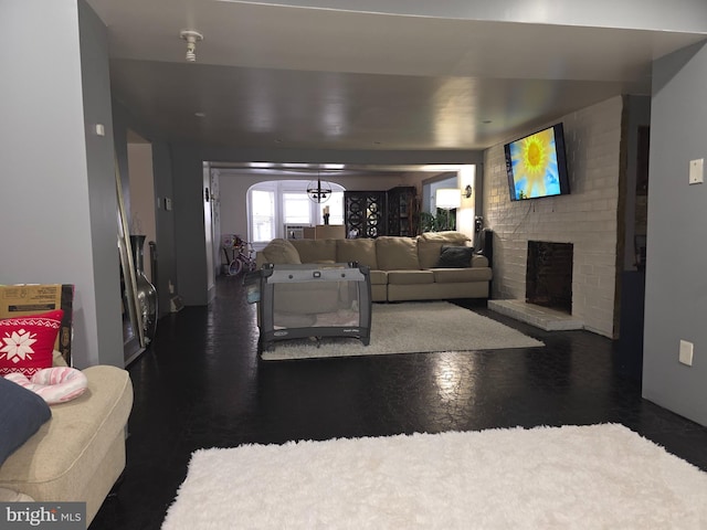 living room featuring a brick fireplace