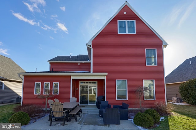 rear view of property with central AC unit and a patio