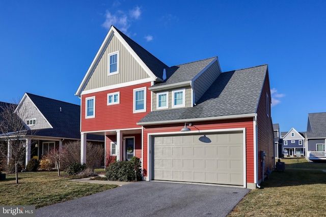 view of front of home with a garage, central AC, and a front lawn