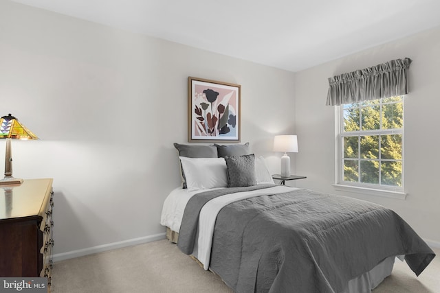 bedroom featuring light carpet