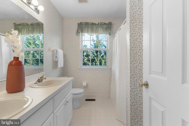 bathroom with vanity, tile patterned floors, and toilet