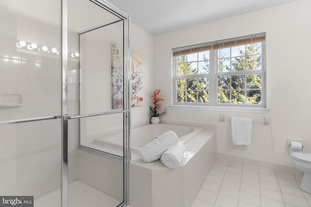 bathroom featuring tile patterned floors, toilet, and independent shower and bath