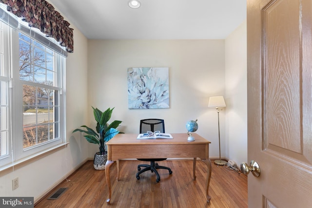 home office with hardwood / wood-style flooring