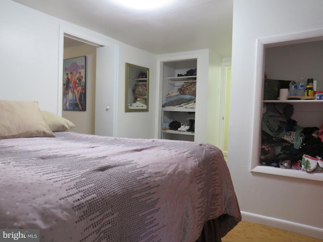 bedroom with hardwood / wood-style floors and a closet