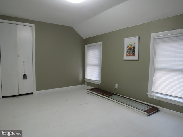 spare room featuring lofted ceiling