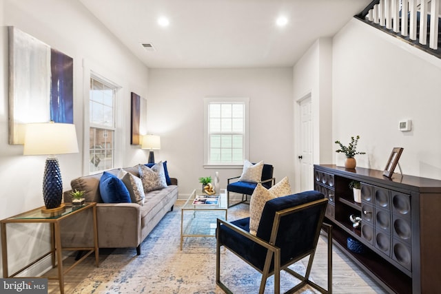 living room featuring recessed lighting, visible vents, and wood finished floors