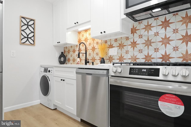 kitchen featuring tasteful backsplash, washer / clothes dryer, white cabinets, stainless steel appliances, and light hardwood / wood-style flooring