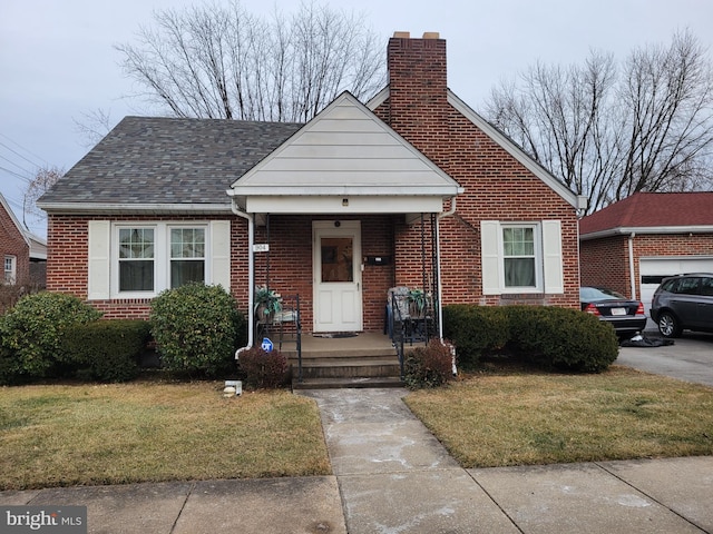 bungalow-style home with a front lawn