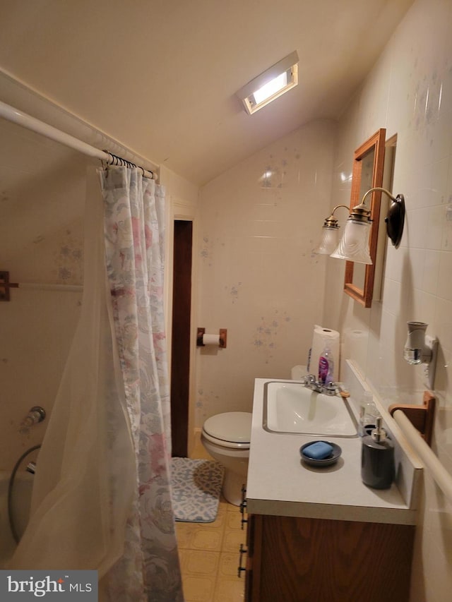 bathroom featuring vanity, vaulted ceiling, toilet, and walk in shower