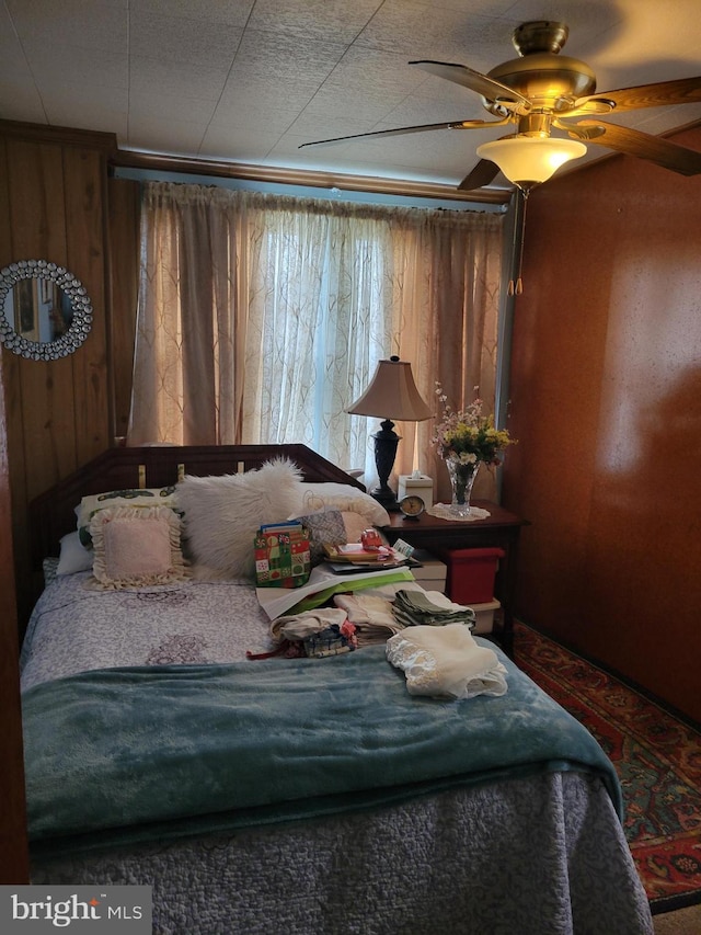 bedroom featuring multiple windows and ceiling fan