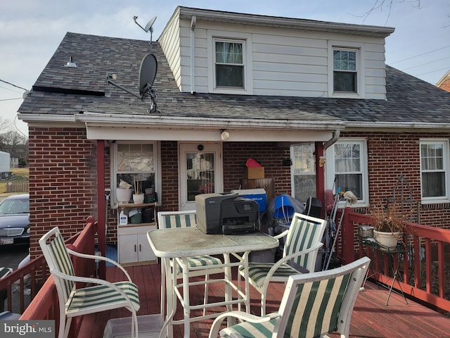 rear view of property featuring a wooden deck