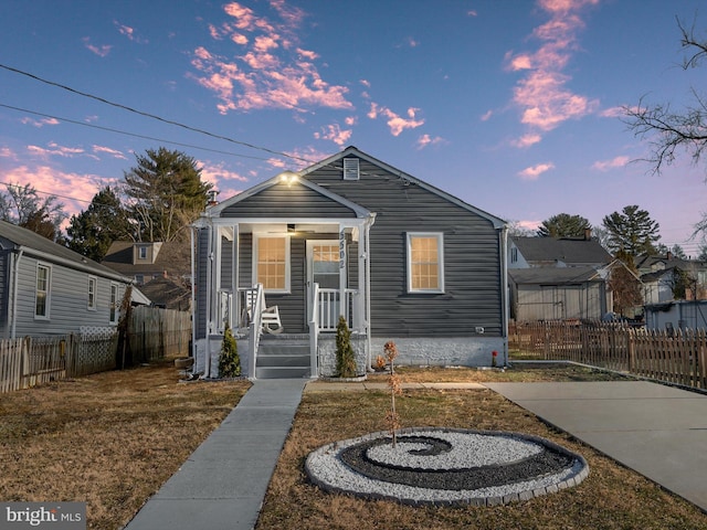 bungalow-style house with a lawn