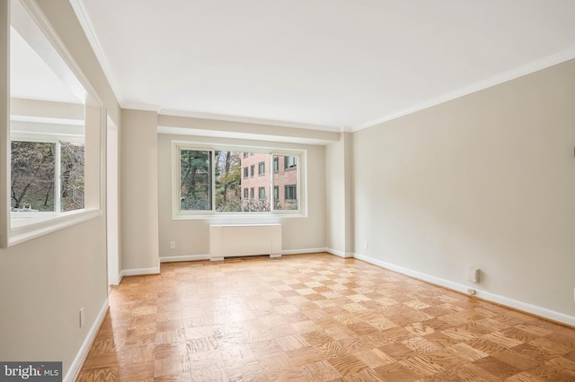 empty room featuring light parquet floors, ornamental molding, and radiator