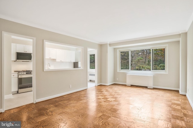 unfurnished living room featuring ornamental molding and radiator