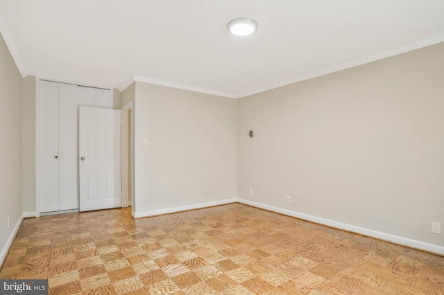 spare room featuring ornamental molding and light parquet flooring